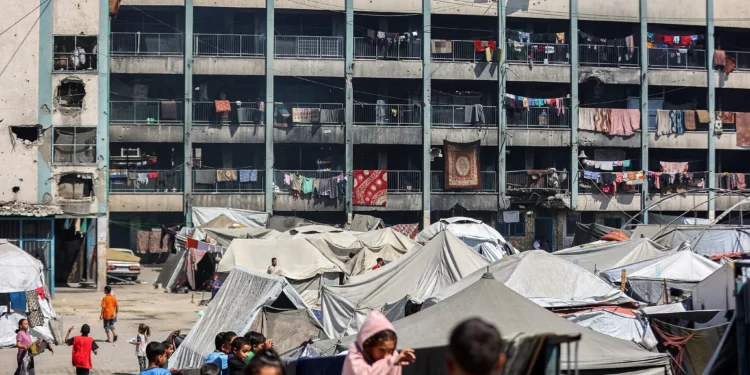 Tiendas de campaña que albergan a personas desplazadas por el conflicto se instalan en el patio de una escuela dirigida por el Organismo de Obras Públicas y Socorro de las Naciones Unidas (OOPS) en Khan Younis, en el sur de la Franja de Gaza, el 30 de septiembre de 2025. (Omar Al-Qattaa / AFP)