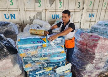 Trabajadores de las Naciones Unidas y de la Media Luna Roja preparan la ayuda para su distribución a los palestinos en un almacén de la UNRWA en Deir al-Balah, Franja de Gaza, el 23 de octubre de 2023. (Foto AP/Hassan Eslaiah)