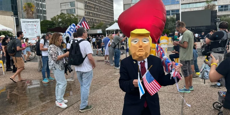 Un hombre con una máscara del presidente estadounidense Donald Trump celebra la noticia de un acuerdo de rehenes en Gaza, en la Plaza de Rehenes de Tel Aviv, el 9 de octubre de 2025. (Ben Sales/Times of Israel)