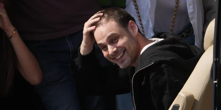 El rehén israelí liberado, Alon Ohel, hace un gesto desde una camioneta al llegar al hospital Beilinson en Petah Tikva, Israel, tras ser liberado del cautiverio de Hamás en la Franja de Gaza, el 13 de octubre de 2025. (Foto AP/Ariel Schalit)