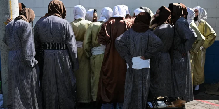 Miembros del culto judío Lev Tahor afuera de la escuela de educación especial Alida España de Arana en la Ciudad de Guatemala el 22 de diciembre de 2024. (Johan ORDÓÑEZ / AFP)