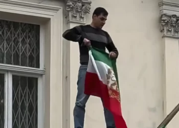 Manifestante sustituye bandera iraní por bandera anterior a Revolución Islámica en embajada en Londres
