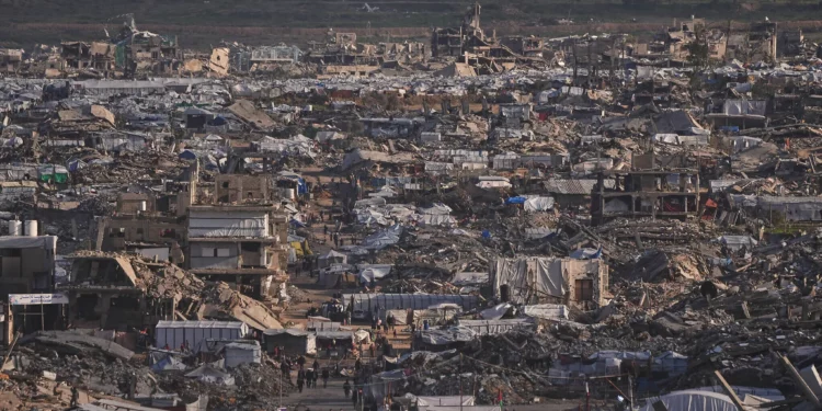 Tiendas de campaña que albergan a evacuados se alzan entre edificios destruidos durante la guerra entre Israel y Hamás en la ciudad de Gaza, el 15 de enero de 2026. (Foto AP/Jehad Alshrafi)