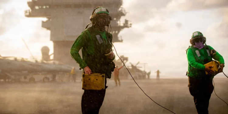 Marineros estadounidenses manejan deflectores de chorro en la cubierta de vuelo del portaaviones más grande del mundo, el portaaviones clase Ford USS Gerald R. Ford (CVN 78), mientras navega por el mar Caribe, el 4 de febrero de 2026 (foto de la Marina de los Estados Unidos).