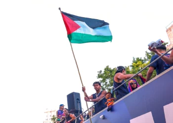 El jugador del FC Barcelona Lamine Yamal sostiene una bandera palestina mientras celebra con su equipo en lo alto de un autobús tras ganar el título de la Liga española de fútbol en Barcelona, España, el 11 de mayo de 2026. (Foto AP)