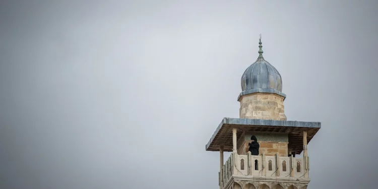 Un hombre observa desde un minarete en la Mezquita de Al-Aqsa en la Ciudad Vieja de Jerusalén el 23 de enero de 2018. (Yonatan Sindel/Flash90)