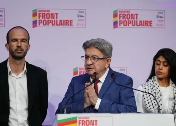 El líder del partido de izquierdas La France Isoumise (LFI), que forma parte de la coalición de izquierdas Nouveau Front Populaire (NFP), Jean-Luc Mélenchon (C), pronuncia un discurso tras el anuncio de los resultados de la primera vuelta de las elecciones parlamentarias en La Faiencerie, París, el 30 de junio de 2024. (Dimitar DILKOFF / AFP)