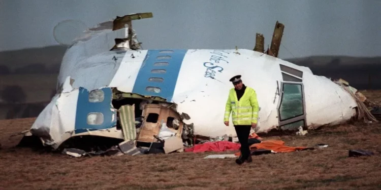 A policeman walking away from the damaged cockpit of the 747 Pan Am airliner that exploded and crashed over Lockerbie, Scotland, with 259 people on board, December 22, 1988. (ROY LETKEY/AFP)