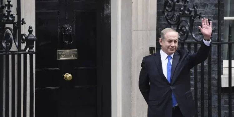El primer ministro Benjamin Netanyahu saluda a los medios de comunicación tras su llegada al número 10 de Downing Street en Londres para una reunión con su homóloga británica, Theresa May, el 6 de febrero de 2017. (Foto AFP/Chris J Ratcliffe)