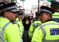 Illustrative: Metropolitan police stand in front of protesters at an anti-Israel, pro-Palestinian demonstration in support of the group Palestine Action as the UK government gears up to ban it, in Trafalgar Square, central London, Great Britain, June 23, 2025. (HENRY NICHOLLS / AFP)