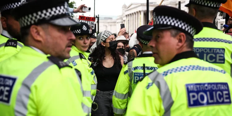 Illustrative: Metropolitan police stand in front of protesters at an anti-Israel, pro-Palestinian demonstration in support of the group Palestine Action as the UK government gears up to ban it, in Trafalgar Square, central London, Great Britain, June 23, 2025. (HENRY NICHOLLS / AFP)