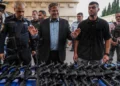 National Security Minister Itamar Ben-Gvir attends an event to deliver weapons to local volunteer security group members in Ashkelon, October 27, 2023. (AP/Tsafrir Abayov)