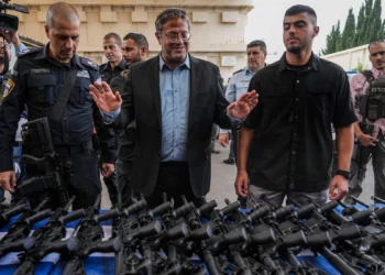 National Security Minister Itamar Ben-Gvir attends an event to deliver weapons to local volunteer security group members in Ashkelon, October 27, 2023. (AP/Tsafrir Abayov)