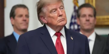 US President Donald Trump listens as Gemini co-founder and president Cameron Winklevoss, left, and Gemini co-founder and CEO Tyler Winklevoss, right, watch, during a meeting with technology leaders in the Roosevelt Room of the White House, August 19, 2026, in Washington. (AP Photo/Jacquelyn Martin)