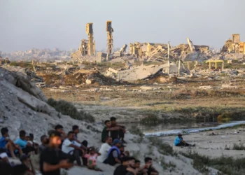 Palestinos cerca de edificios destruidos durante la reciente guerra entre Israel y Hamás, en la ciudad de Gaza, en el centro de la Franja de Gaza, el 31 de julio de 2026. (Ali Hassan/Flash90)