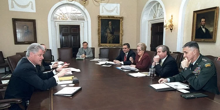 US President Bill Clinton meets with his National Security team on April 7, 1999, in the White House Cabinet Room. From left: Clinton, Steve Ricchetti, Gen. Donald Kerrick, CIA Director George Tenet, Secretary of State Madeleine Albright, Samuel Berger, and Gen. Hugh Shelton.