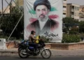 A man drives past a banner showing a portrait of Iranian Supreme Leader Ayatollah Mojtaba Khamenei, in downtown Tehran, Iran, August 31, 2026. (AP Photo/Vahid Salemi)