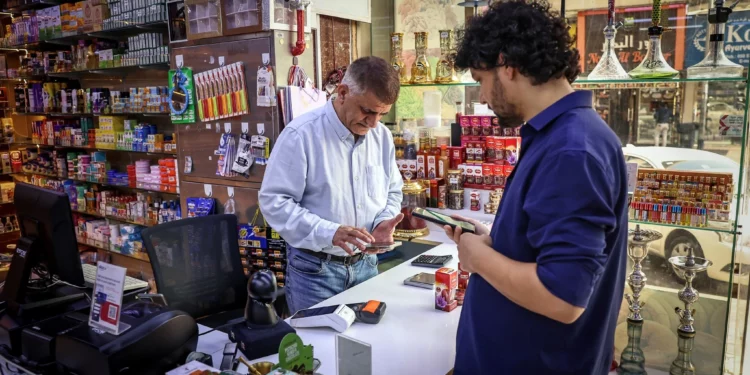 El comerciante iraní Morteza Asaadi atiende a un cliente en su tienda en el centro de Bur Dubai el 3 de septiembre de 2026.