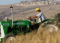 Man drivers tractor on Israeli kibbutz (illustrative)
