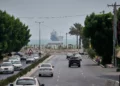 El tráfico circula por una avenida mientras un buque mercante permanece anclado en el estrecho de Ormuz frente a Bandar Abbas, Irán, el 7 de septiembre de 2026.