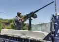 A member of the Saudi-backed Yemeni government forces, including National Army and Taiz Axis forces, mans a turret mounted on the back of a pickup truck at a checkpoint along the Kadha frontline west of Taiz in western Yemen, on September 13, 2026. (AFP)