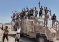 This image taken from undated video released by the Houthi-run Al-Masirah television channel on September 12, 2026, shows Houthi fighters chanting and raising rifles atop a military vehicle in Dhubab district, Taiz province, Yemen, according to the channel. (Al-Masirah TV via AP)
