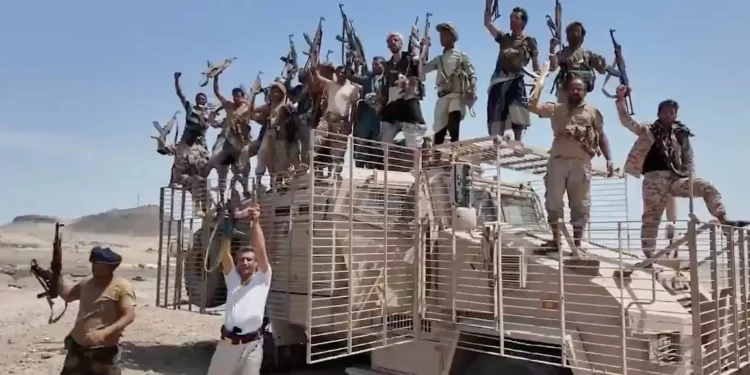 This image taken from undated video released by the Houthi-run Al-Masirah television channel on September 12, 2026, shows Houthi fighters chanting and raising rifles atop a military vehicle in Dhubab district, Taiz province, Yemen, according to the channel. (Al-Masirah TV via AP)