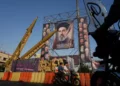 Motorbikes drive past Iranian missiles and banners showing portraits of the Iranian Supreme Leader Ayatollah Mojtaba Khamenei, center, and the late armed forces commanders and nuclear scientists, who were killed in Israeli and US strikes, at Baharestan Square, in Tehran, September 28, 2026. (AP/Vahid Salemi)