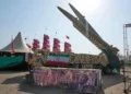 Iranian missiles are displayed by the armed forces as an anti-Trump banner declaring in English and Farsi, 'We will kill you,' is seen in a temporary exhibition at Azadi (Freedom) Square in Tehran, Iran, July 29, 2026. (AP Photo/Vahid Salemi)