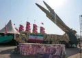 Iranian missiles are displayed by the armed forces as an anti-Trump banner declaring in English and Farsi, 'We will kill you,' is seen in a temporary exhibition at Azadi (Freedom) Square in Tehran, Iran, July 29, 2026. (AP Photo/Vahid Salemi)