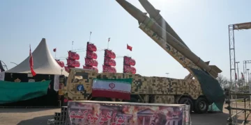 Iranian missiles are displayed by the armed forces as an anti-Trump banner declaring in English and Farsi, 'We will kill you,' is seen in a temporary exhibition at Azadi (Freedom) Square in Tehran, Iran, July 29, 2026. (AP Photo/Vahid Salemi)