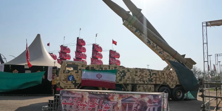 Iranian missiles are displayed by the armed forces as an anti-Trump banner declaring in English and Farsi, 'We will kill you,' is seen in a temporary exhibition at Azadi (Freedom) Square in Tehran, Iran, July 29, 2026. (AP Photo/Vahid Salemi)