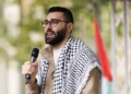 Palestinian photojournalist Motaz Azaiza speaks to the crowd at the end of the 14th national march for Palestine on May 18, 2024 in London, England.