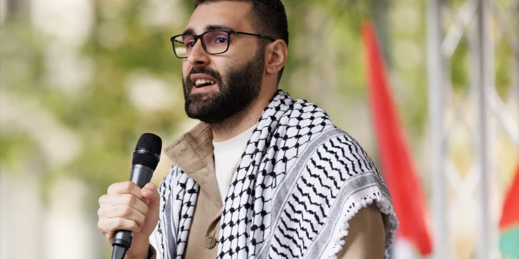 Palestinian photojournalist Motaz Azaiza speaks to the crowd at the end of the 14th national march for Palestine on May 18, 2024 in London, England.