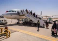 Passengers disembark an Iranian plane in Najaf airport after the end of a flight suspension caused by the regional war that began after US and Israeli strikes on Iran, in Najaf, Iraq, May 8, 2026. (AP Photo/Anmar Khalil)