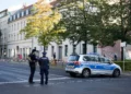 German police officers stand guard in front of the building complex of the Kahal Adass Jisroel community, which houses a synagogue, a kindergarten and a community center, in the center of Berlin, Germany, October 18, 2023. (AP/Markus Schreiber)