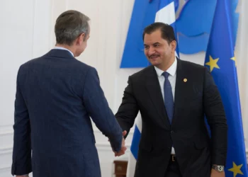 Deputy Commander of the Libyan National Army, Lieutenant General Saddam Haftar, right, shakes hands with Greece’s Prime Minister Kyriakos Mitsotakis, in Athens, on June 15, 2026. (AP/Petros Giannakouris)