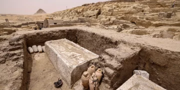 Visitors tour the site in the Saqqara necropolis south of Cairo, where archaeologists unearthed two human and animal embalming workshops, as well as two tombs, on May 27, 2023. (Khaled Desouki/AFP)