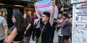 A protester holds a transgender flag during a demonstration against the arrests of LGBTQ activists in Izmir, on September 14, 2026. (Murat Kocabas/AFP)