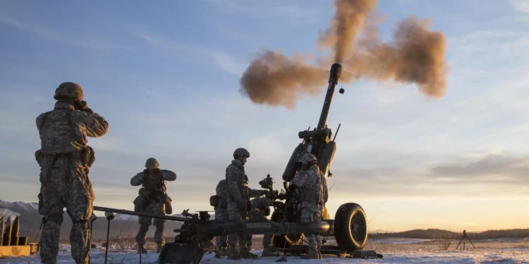 Artilleros del Ejército estadounidense operan un obús remolcado durante actividades de entrenamiento en Alaska.