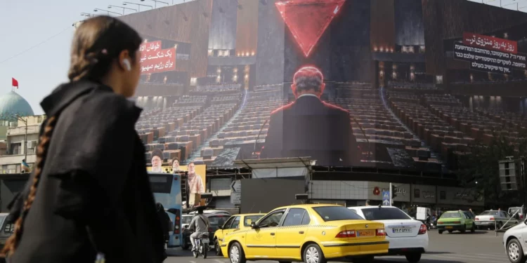 Un enorme cartel contra Israel y Benjamin Netanyahu en la plaza Enghelab de Teherán, el 12 de octubre de 2026, muestra al primer ministro ante una sala vacía.