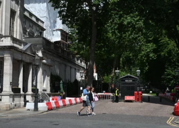 People walk past the gated entrance to the road housing the Israeli embassy in London on June 15, 2025. (Justin Tallis/AFP)
