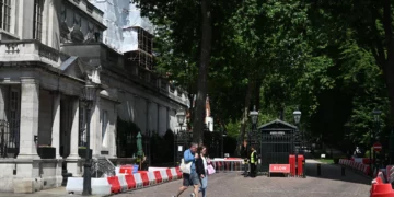People walk past the gated entrance to the road housing the Israeli embassy in London on June 15, 2025. (Justin Tallis/AFP)