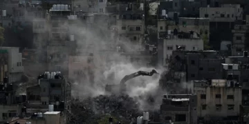 An Israeli army bulldozer demolishes homes in the Palestinian urban refugee camp of Nur Shams, near the West Bank city of Tulkarem, December 31, 2025. (AP/Majdi Mohammed)