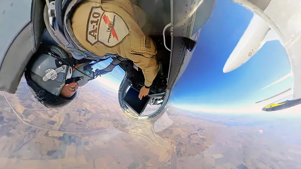 Operador en el asiento trasero de un L-39 utiliza un dispositivo tipo tableta en una prueba de control de drones