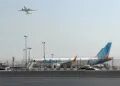 A plane takes off as a flydubai aircraft sits on the tarmac at Dubai International Airport in Dubai, United Arab Emirates, September 30, 2026. (AP Photo)